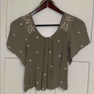 Olive green crop top with white flowers throughout